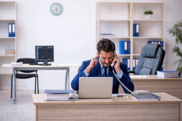 Young male employee working in the office