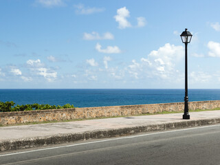 City coast mural street with a lamp post and the ocean in the background from puerto rico san juan...