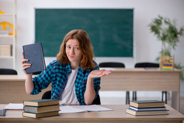 Young female student preparing for exam in the classroom