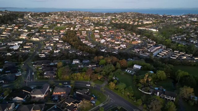 Drone shot of Devonport with the sea view at sunrise, cloudy sky background, Auckland, New Zealand