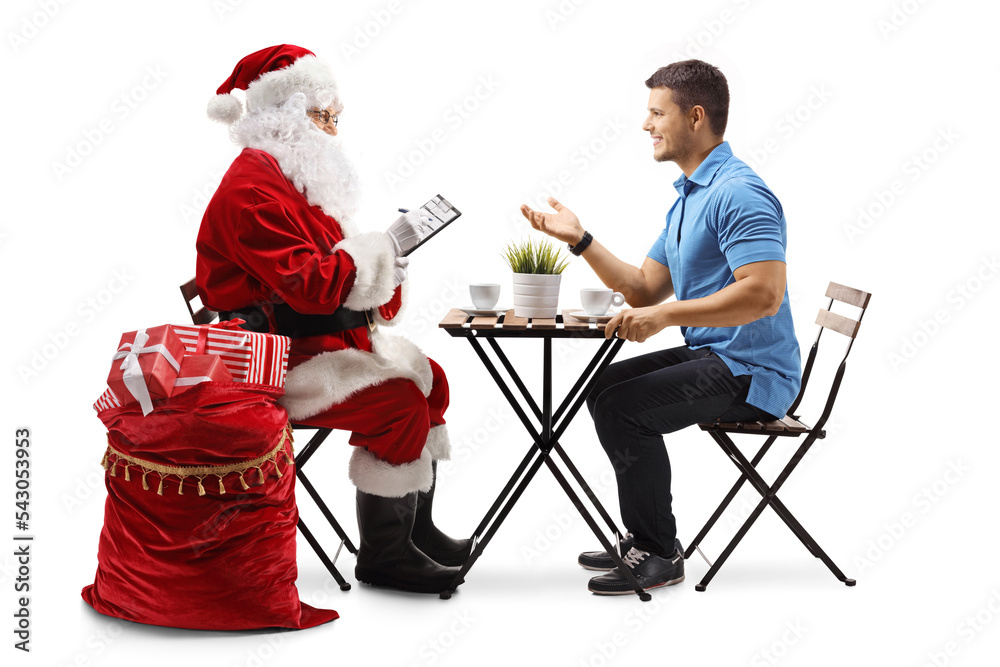 Canvas Prints Santa Claus writing a list and young man sitting and talking in a cafe