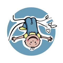 Happy little child hanging upside down on a tree branch