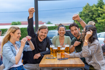 Happy friends drinking beer in a bar