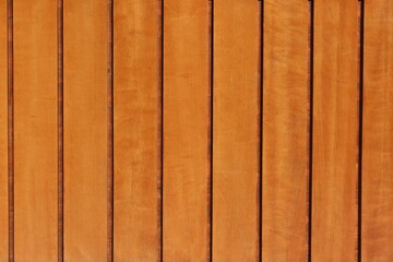 Obraz premium Fondo con detalle y textura de varios listones de madera con vetas y diferentes tonos anaranjados suaves