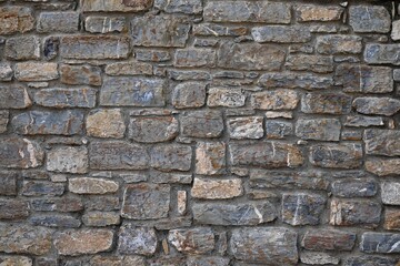 Fondo con detalle y textura de superficie con multitud de piedras, en diferentes tamaños y colores, con tonos grises y marrones