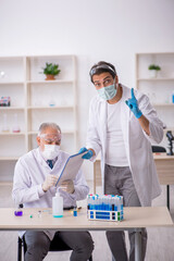 Two male chemist working at the lab