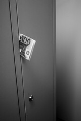 a hundred euro banknote is stuck in a locker