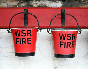 Two fire buckets hanging on a wall