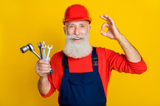 Photo of professional artisan handyman make okay sign hold mechanic keys equipment isolated on bright color background