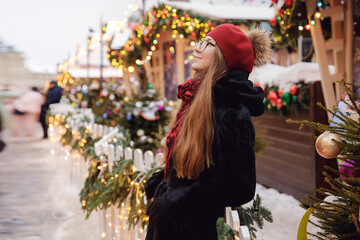 Winter portrait of young happy woman in wearing warm clothes. Concept tourist travel Christmas...
