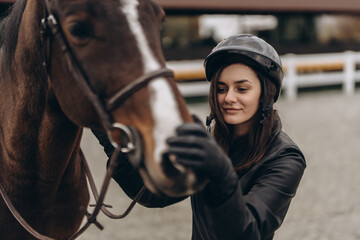 Equestrian competitions. A woman and a horse are preparing for a race.