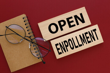 Open Enrollment . two wooden blocks on a red background. text on wood