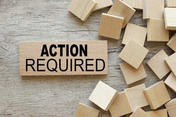 ACTION REQUIRED. text on wood near wooden cubes