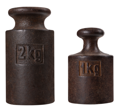 Metal one and two kilogram weights for an old analog scale on an isolated background.