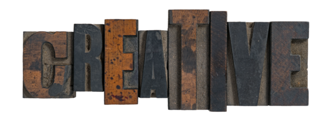 Isolated word creative spelled out in vintage wooden letterpress type