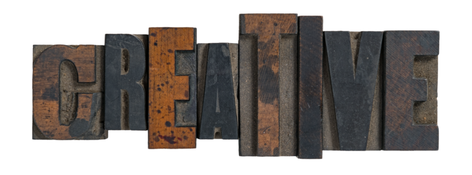 Isolated word creative spelled out in vintage wooden letterpress type