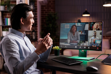 Male freelancer talking to colleagues on videoconference, attending business meeting online on...