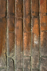 Fototapeta premium brick wall of red color, wide panorama of masonry. Old brick wall with shadow texture. cracked bricks, with a weathered and faded surface. Restored brickwork of an old house.