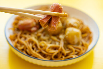 angle view dish of cart noodles with curry fish balls and sausages