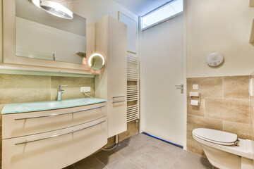 Bathroom with white tiled walls and open shower near sink base cabinet in light
