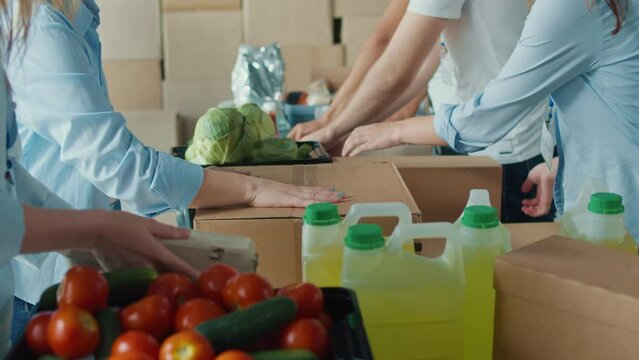 Close-up. Hands of Volunteers Sorting Humanitarian Aid at Distribution or Refugee Assistance Center. The Concept of Social Aid. Internally Displaced Persons. Charity Project or Donating Aid