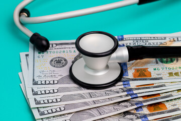 Stethoscope and cash money. Healthcare, health insurance and medical bills concept.
