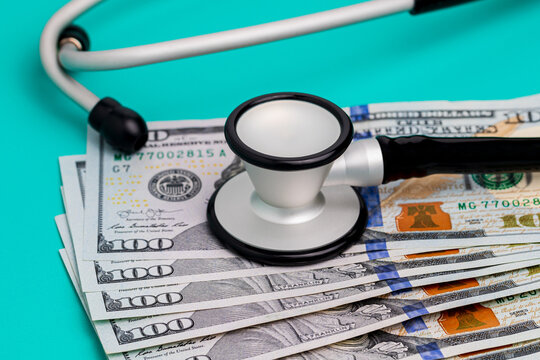 Stethoscope And Cash Money. Healthcare, Health Insurance And Medical Bills Concept.