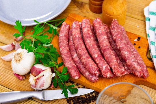 Delicious longaniza from minced meat on wooden surface, pork sausage. Popular Catalan sort of sausages