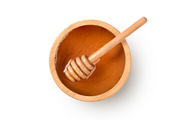 Top view Honey in wooden bowl with dipper on white background.