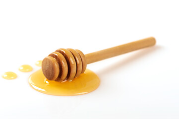 Honey and dipper on white background.
