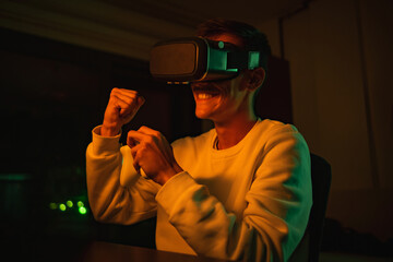 young man in vr glasses plays virtual reality game in metaverse universe and experiences different emotions