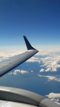Aerial view of blue sky and clouds in an airplane, Travel or transportation, Vertical video for smartphone footage
