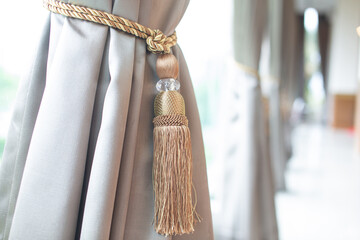 Curtains with curtain fasteners on gray windows