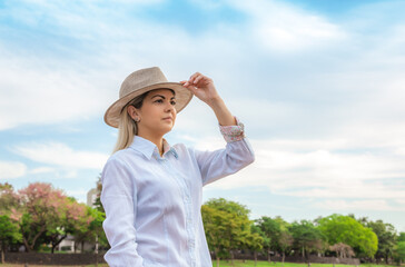 Agribusiness woman wearing hat and jeans at the end of a working day..