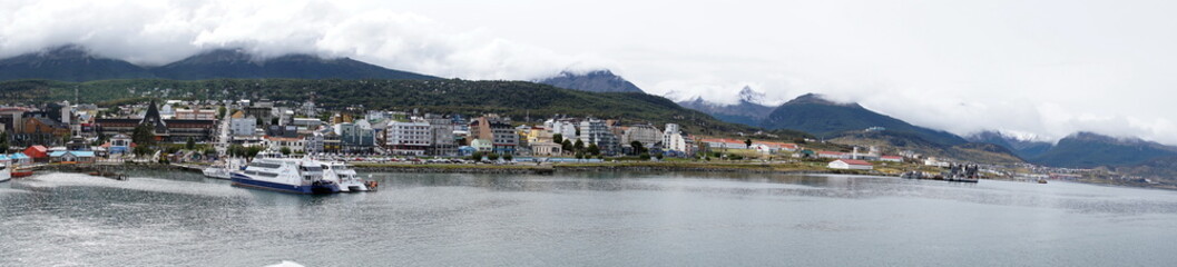 Fototapeta na wymiar Panorama of the city of Ushuaia, Argentina, with the commercial pier, seen from the Beagle Channel