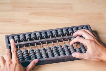 Chinese traditional calculator, old abacus on wooden background