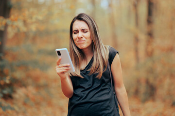 Woman Squinting Trying to See on the Mobile Phone Display. Person with vision problems having...