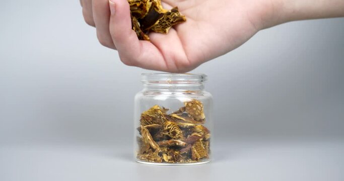 dried fly agaric in a jar for the microdosing use closeup, hack mind mushrooms. High quality 4k footage