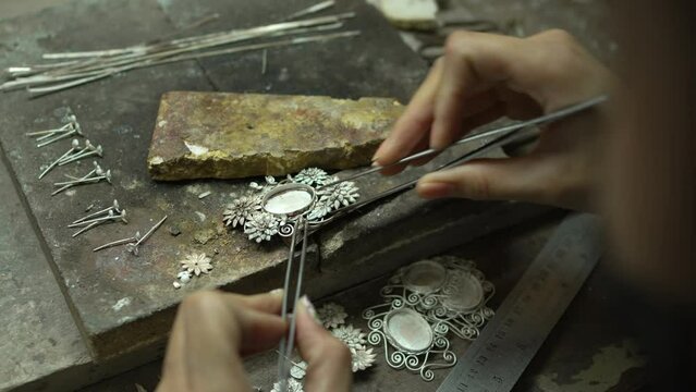 Jeweler at work in jewelry. Desktop for craft jewelry making with professional tools. Close up view of tools. Thailand. 
