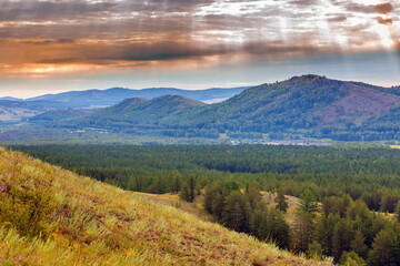 South Ural, Ural mountains in summer. Sunset in the mountains. The top of the mountain range. Summer day.
