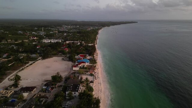 Uroa beach shore homes in Zanzibar Island Tanzania Africa at sundown, Aerial flyover shot