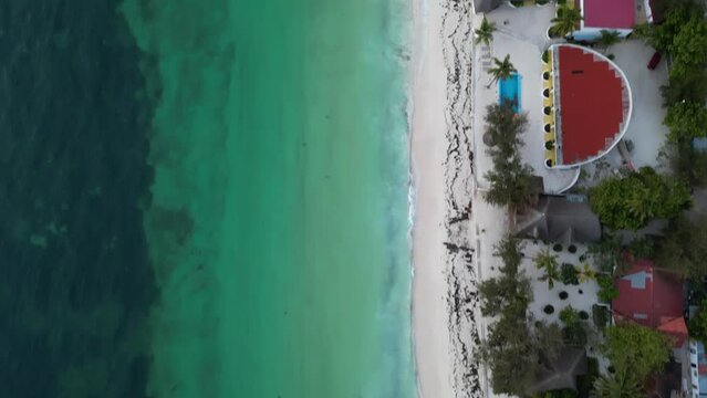 Uroa beach homes with swimming pools in Zanzibar Island Tanzania Africa, Aerial top view tilt up reveal shot