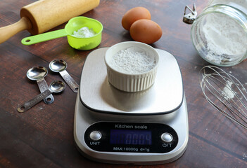 Kitchen digital scale with flour on the top - Preparation for bakery baking concept