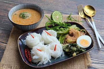 Kanom Jeen Nam Prik - Thai rice noodles with peanut sauce on wood table, Thai authentic food