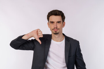 Portrait of young businessman shows sign of dislike, looks with negative expression and disapproval...