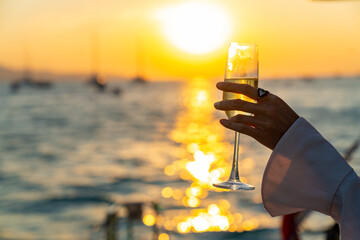 Caucasian woman hand holding champagne glass relax and enjoy luxury outdoor lifestyle while travel...
