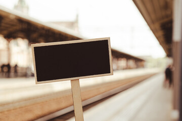 Empty mockup template Blackboard label against defocused background railway station with...
