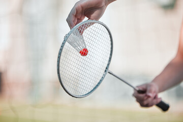 Sports, badminton and shuttlecock with racket and hands of woman training for games, competition and health. Match, workout and exercise with athlete ready to serve for goal, fitness and action