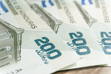A macro photograph of a pair of 200 lempiras bills.