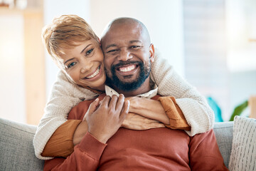 Marriage, couple and hug portrait at sofa with loyalty, happiness and care in home lounge. Love, black woman and black man relax in house living room together with happy smile and embrace.